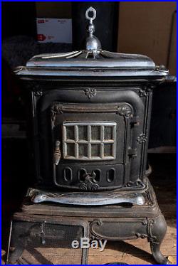 Vintage wood burning cast iron parlor stove (with original manual